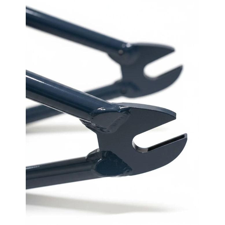 Close-up of two dark blue fork dropouts from the United Pro Model Frame (Marius Dietsche Signature)—crafted from 4130 Sanko Japanese tubing—against a white background.