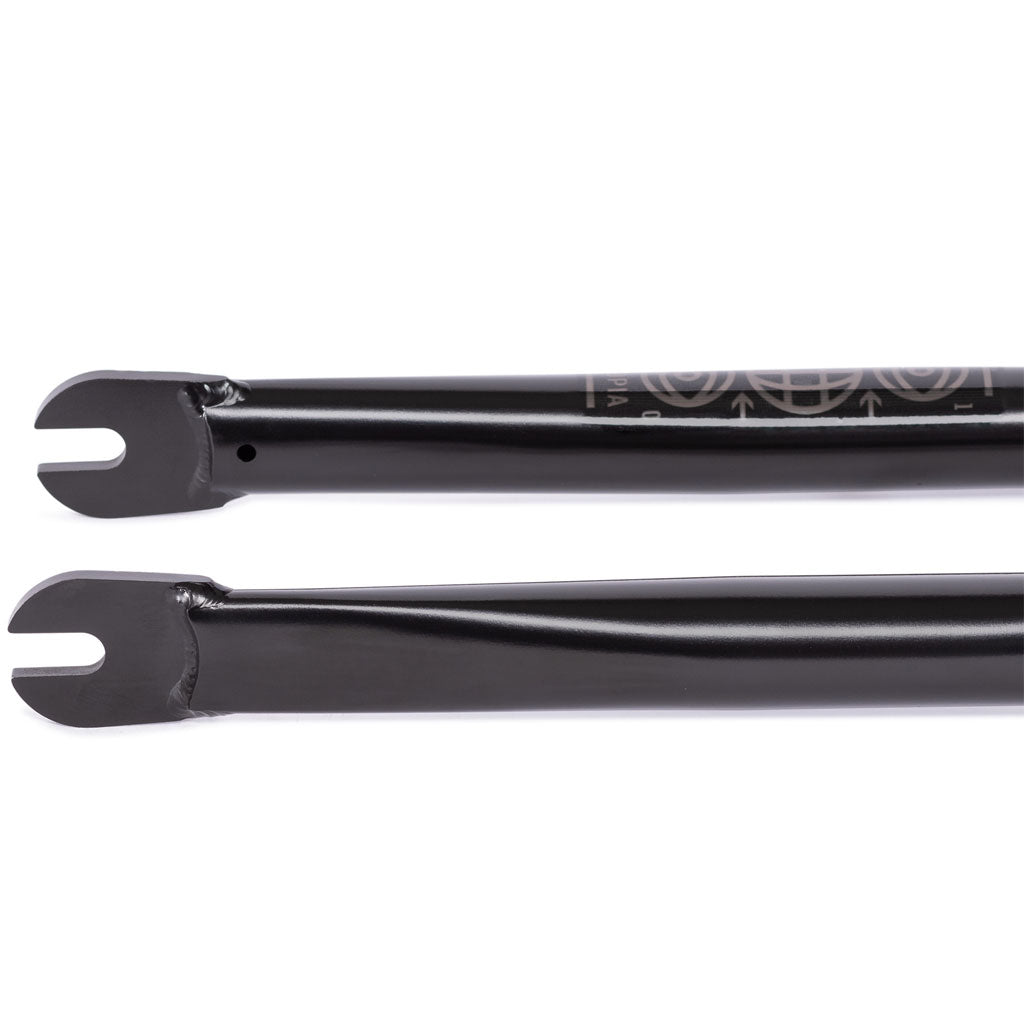 Two U-shaped black fork dropouts are placed parallel on a white background, highlighting the precision of CNC'd steerers used in crafting the Utopia Zero (With Mounts) Flatland Fork with zero-offset.