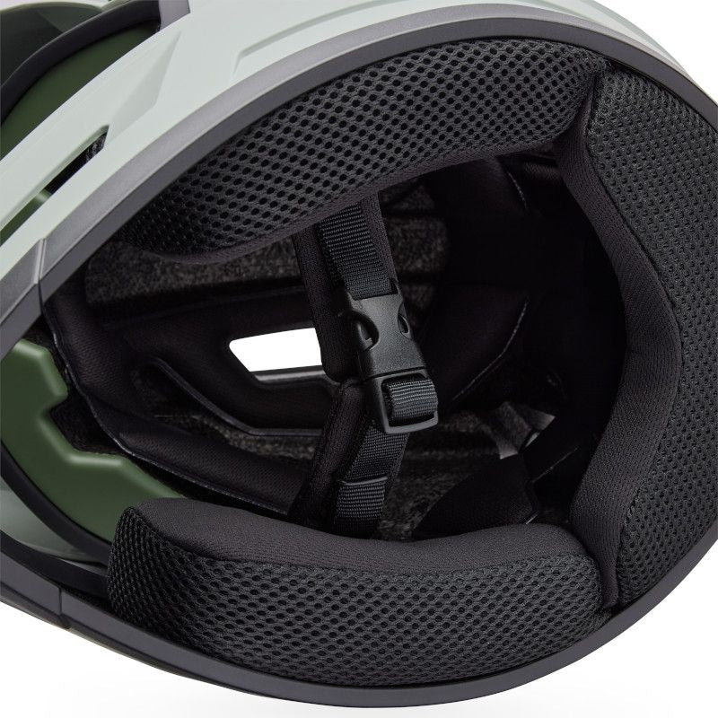Close-up of the Bell Sanction 2 Dark Grey’s interior padding and chin strap, featuring black mesh lining and a plastic buckle—perfect for an entry-level or kids’ bike helmet.
