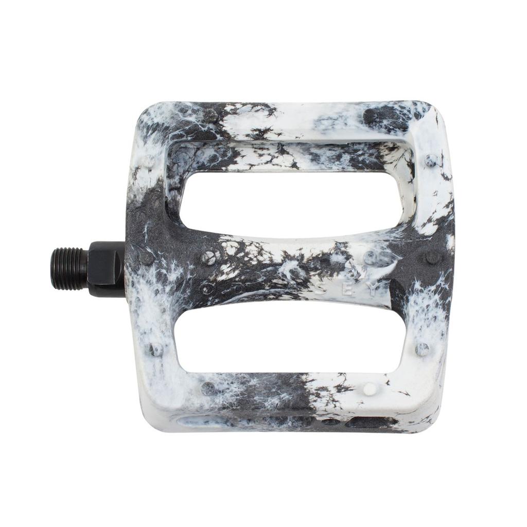 The Odyssey Twisted PC Pro Pedals feature a rectangular shape, marbled black and white design, two large cutouts, and a durable nylon composite build—perfect BMX pedals for top performance, shown here from above.