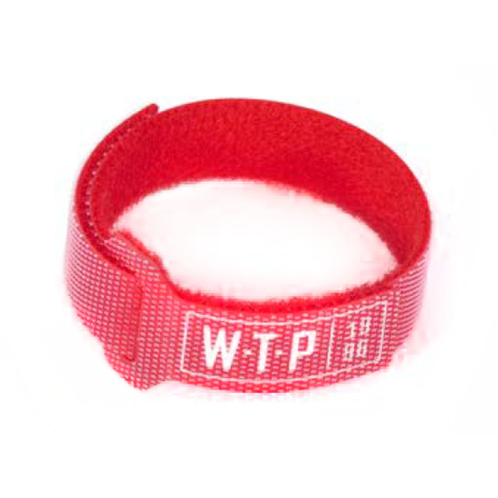 A red Wethepeople Brake Cable Velcro Holder with white "WTP" text, coiled in a loop—ideal for use as a cable slap stopper.