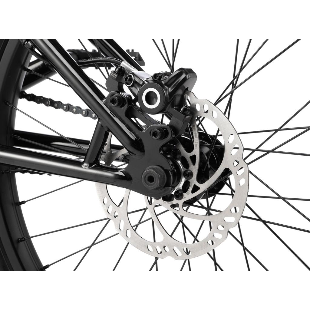 Close-up of the rear wheel on a Wethepeople Havoc 22 Inch Bike, highlighting the disc brake rotor, caliper, and spokes—ideal for BMX fans and bike enthusiasts.
