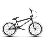 The Wethepeople Nova 20 Inch Bike features a black frame with white tires, adorned with the "WETHEPEOPLE" logo, and includes Salt Rookie Cranks for extra performance. Its sleek design ensures a ride that's both stylish and robust.
