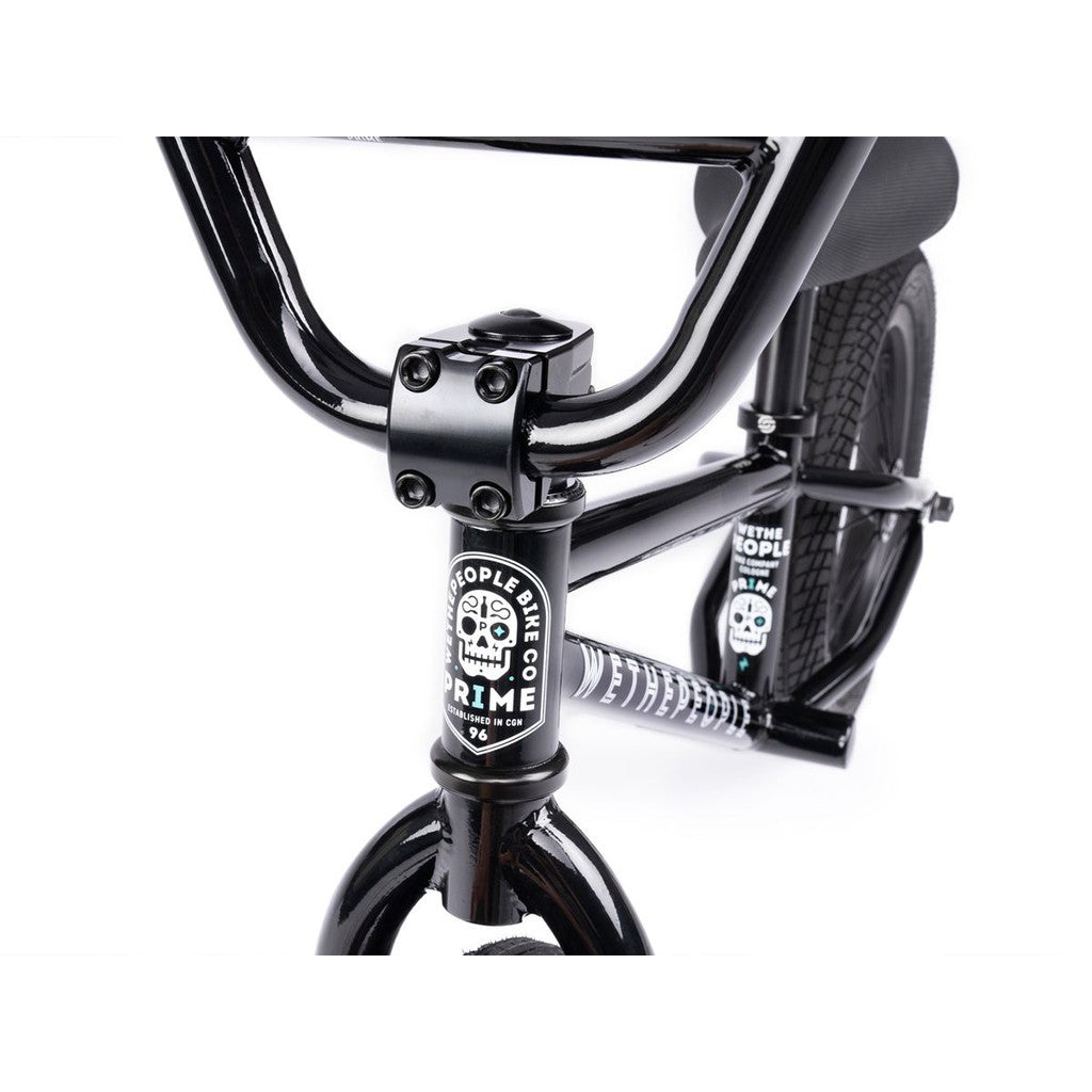 Close-up of the Wethepeople Prime 12 Inch Balance Bike’s black front end, showcasing the handlebars, stem, fork, and "Wethepeople Prime" branding with skull graphics.