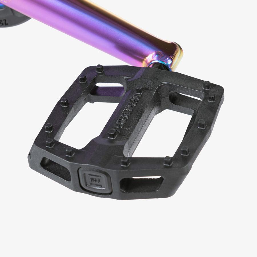 A Wethepeople Reason 20 Inch BMX Bike with a rainbow colored handlebar.