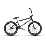 The Wethepeople Reason Shift 20 Inch Bike is a premium black BMX with a chromoly frame, flat seat, thick tires, and distinctive purple pedal cranks.