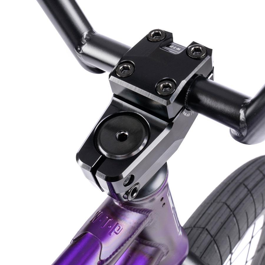 Close-up of the black handlebar and stem on a Wethepeople Trust 20 Inch Freecoaster/Hybrid Bike with a purple battleship geometry frame.