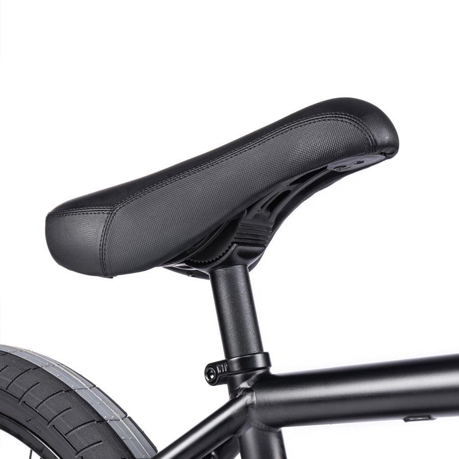 Close-up of a black bicycle seat and part of the Wethepeople Trust 20 Inch Freecoaster/Hybrid Bike frame.
