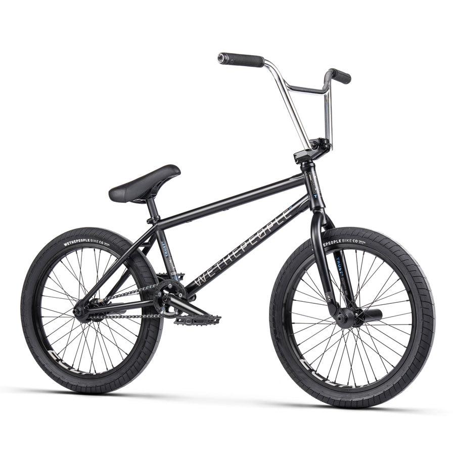 A Wethepeople Trust 20 Inch Freecoaster/Hybrid Bike in black, designed with battleship geometry, large handlebars, thick tires, and a padded seat on a white background.
