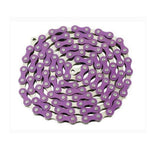 A coiled bike chain in silver and purple, similar to the lively designs of the YBN Freestyle chain 1/2-1/8, is neatly laid out on a white background.