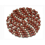 A coiled YBN Freestyle chain 1/2-1/8 in red lies against a white background, highlighting the vibrant appeal of colored chains.