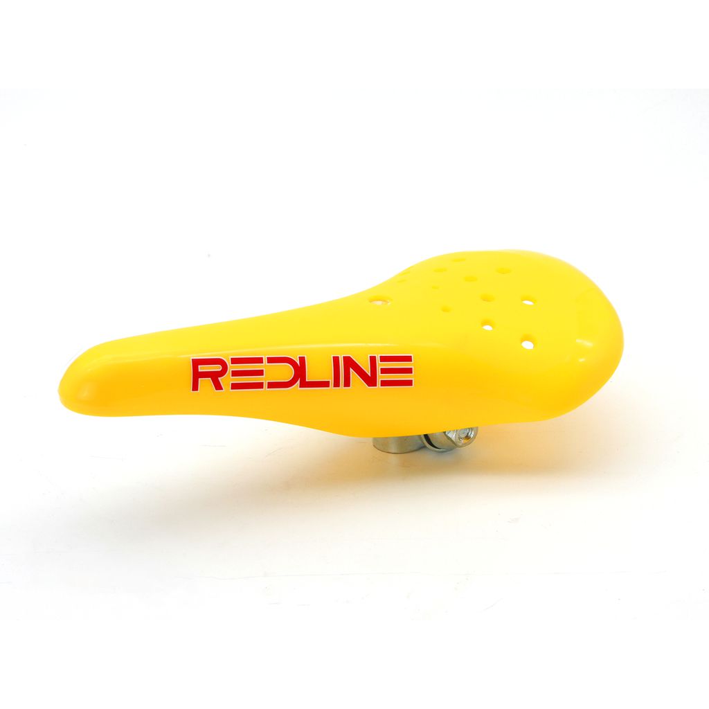 A yellow bicycle seat with red text, Redline Elina Style Railed Seat, original spec.